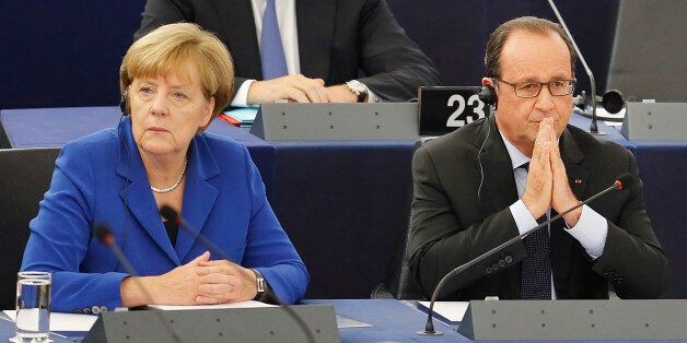 German Chancellor Angela Merkel, left, is seated next to French President Francois Hollande before addressing the members of the European Parliament in Strasbourg, eastern France, Wednesday, Oct. 7, 2015. Angela Merkel and Francois Hollande are making a historic appeal to the European Parliament on Wednesday. It's the first such joint appearance since 1989, when West German Chancellor Helmut Kohl and French President Francois Mitterrand spoke in Strasbourg days after the fall of the Berlin Wall. (AP Photo/Michael Probst)