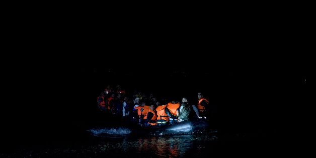 Syrian refugees arrive on the shores of the Greek island of Lesbos after crossing the Aegean sea on a inflatable dinghy from Turkey, Friday, Sept. 25, 2015. More than 260,000 asylum-seekers have arrived in Greece so far this year, most reaching the country's eastern islands on flimsy rafts or boats from the nearby Turkish coast. (AP Photo/Petros Giannakouris)