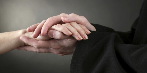 Priest holding woman hands, on green background