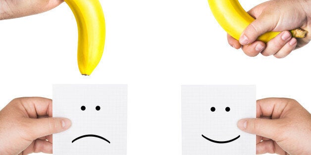 concept of potency, the concept of penis, two men's hands holding smiley and sad faces, two hands hold the big bananas up and down, like the man penis, short, small, medium, average, long size