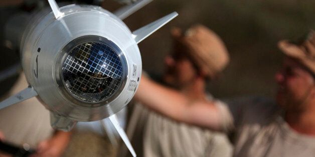 In this photo taken from Russian Defense Ministry official web site on Tuesday, Oct. 6, 2015, Russian military support crew inspect missiles attached to their jet at an air base in Syria. at an air base Hmeimim in Syria. A spokeswoman for the Russian foreign ministry has rejected claims that Russia in its airstrikes in Syria is targeting civilians or opposition forces. (Russian Defense Ministry Press Service via AP)