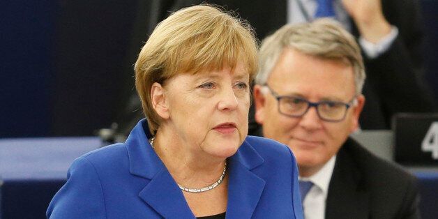 German Chancellor Angela Merkel gestures as she delivers her speech as part of a joint appearance with French President Francois Hollande, right, at the European Parliament in Strasbourg, eastern France, Wednesday, Oct. 7, 2015. Angela Merkel and Francois Hollande are making a historic appeal to the European Parliament on Wednesday. It's the first such joint appearance since 1989, when West German Chancellor Helmut Kohl and French President Francois Mitterrand spoke in Strasbourg days after the fall of the Berlin Wall. (AP Photo/Michael Probst)