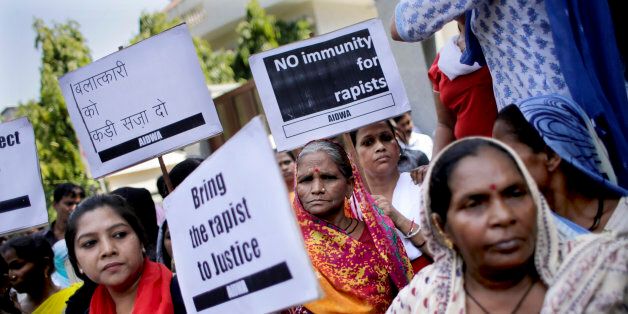 Activists of All India Democratic Women's Association hold placards during a protest outside the Saudi Arabian embassy in New Delhi, India, Thursday, Sept. 10, 2015. Police in India were investigating complaints from two women that a Saudi Arabian diplomat raped them repeatedly and confined them in his home near New Delhi. He has claimed diplomatic immunity, and the Saudi embassy in a statement Wednesday denied all the allegations. Placard on top left reads,