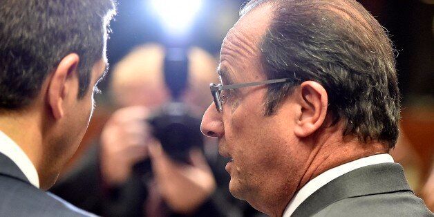 French President Francois Hollande, right, and Greek Prime Minister Alexis Tsipras standing in the flashlight during the EU summit in Brussels, Belgium on Thursday, Oct. 15, 2015. European Union heads of state meet to discuss, among other issues, the current migration crisis. (AP Photo/Martin Meissner)