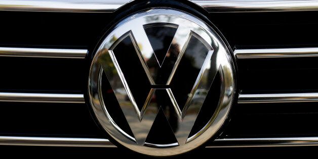 The VW sign of Germany's car company Volkswagen at the radiator grill of a VW car photographed in, Berlin, Germany, Monday, Oct. 5, 2015. (AP Photo/Markus Schreiber)