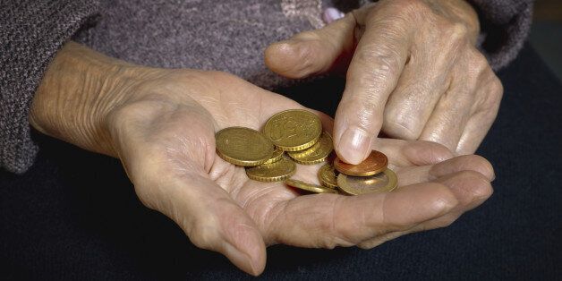 Euro coins in old woman's hands. Bussines concept.