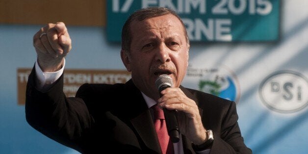 Turkish President Recep Tayyip Erdogan gestures as he delivers a speech during the inauguration ceremony of a water pipeline connecting Turkey to the breakaway Turkish Republic of Northern Cyprus on October 17, 2015, in Camlibel village (Myrtou) near the divided island's northwestern town of Morphou. The Greek Cypriot foreign ministry said on October 15, 2015, the construction of the 106-kilometre (65 mile) underwater pipeline taking water from a damn near the Turkish port of Mersin to breakaway