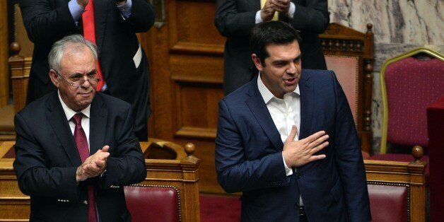 Greek prime minister Alexis Tsipras (R) acknowledges the applauds, after his speech prior to a confidence vote of the new government at the Greek parliament in Athens on October 8, 2015. AFP PHOTO/ LOUISA GOULIAMAKI (Photo credit should read LOUISA GOULIAMAKI/AFP/Getty Images)