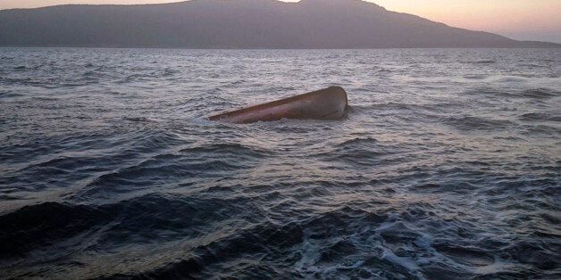 In this picture made available by the Turkish Coast Guard on Wednesday, June 24, 2015, a capsized boat used by migrants to try to cross to Kos island in Greece, is seen in the Aegean sea off the coast of Bodrum, Turkey. Authorities in the Turkish city of Izmir say six migrants drowned in waters off the Greek island of Kos. The Izmir governorship said Wednesday that six coast guard vessels and a helicopter were involved in a rescue of 70 migrants off a sinking ship early Tuesday. (Turkish Coast G