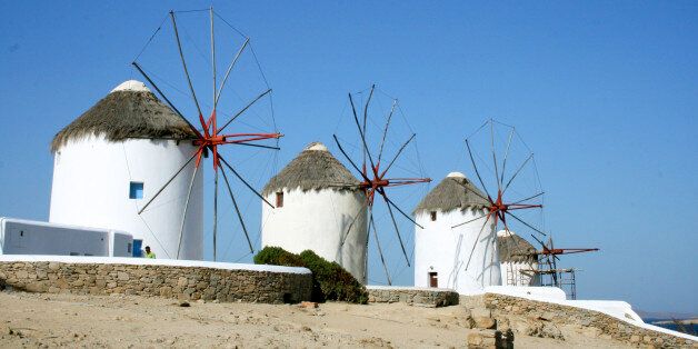 This July 6, 2014 photo shows picturesque windmills on the island of Mykonos in the Cyclades, a Greek island chain in the Aegean Sea. The tradition of building windmills on the island dates back centuries. The Cyclades are known for panoramic views of the sea, homes tucked into cliffsides and waterfronts, black-sand beaches and dramatic sunsets. (AP Photo/Kristi Eaton)