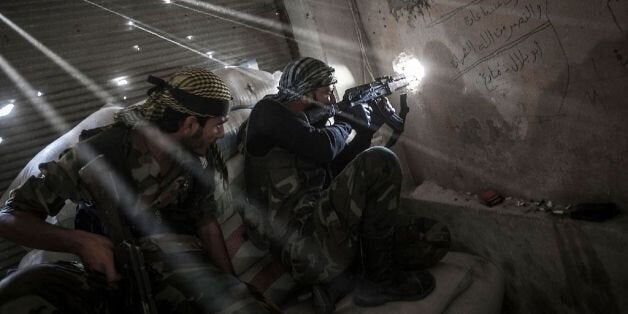 October 21, 2012 - Aleppo, Syria USA: Rebel fighters belonging to the Javata Harria Sham Qatebee watch over the enemy position during skirmishes at the first line of fire in Karmal Jabl neighborhood, district of Arkup, at the northeast of Aleppo CIty. (Narciso Contreras/POLARIS)