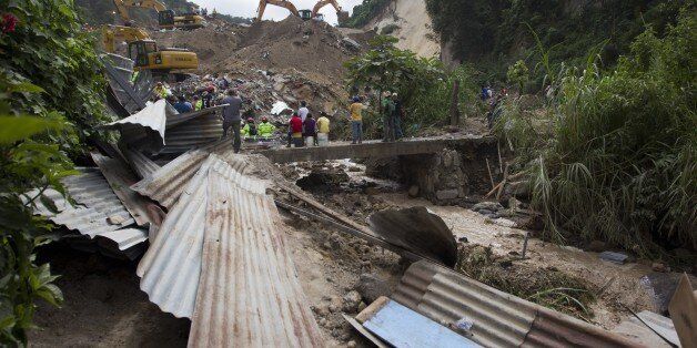 GUATEMALA CITY, GUATEMALA - OCTOBER 03 : Rescue workers and firemen search for survivors at the site of a of landslide in the municipality of Santa Catarina Pinula, about 10 miles east of Guatemala City, Oct. 3, 2015. The mudslide that occured on 01 October killed some 69 people and 450 are reported still missing. (Photo by Stringer/Anadolu Agency/Getty Images)