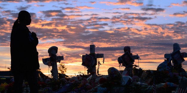 AURORA, CO - JULY 29: People continue to visit the roadside memorial set up for victims of the theaters shooting massacre across the street from Century 16 movie theater at sunrise July 29, 2012 in Aurora, Colorado. Twenty-four-year-old James Holmes is suspected of killing 12 and injuring 58 others on July 20 during a shooting rampage at a screening of 'The Dark Knight Rises' in Aurora, Colorado. (Photo by Kevork Djansezian/Getty Images)