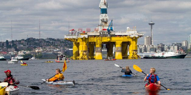 SEATTLE, WA - MAY 14: Environmental activists in kayaks protest the arrival of the Polar Pioneer, an oil drilling rig owned by Shell Oil, on May 14, 2015 in Seattle, Washington. The rig is part of a fleet that will lead a controversial oil-exploration effort off Alaska's North Slope. (Photo by Karen Ducey/Getty Images)