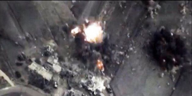 In this photo made from the footage taken from Russian Defense Ministry official web site on Thursday, Oct. 1, 2015 a bomb explosion is seen in Syria. Russiaâs launch of airstrikes in Syria is prompting discussions within the Pentagon about whether the U.S. should use military force to protect U.S.-trained and equipped Syrian rebels if they come under fire by the Russians. (AP Photo/ Russian Defense Ministry Press Service)