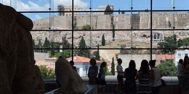 Tourists visit the Acropolis museum in Athens on July 7, 2015. Eurozone leaders will hold an emergency summit in Brussels on July 7 to discuss the fallout from Greek voters' defiant 'No' to further austerity measures, with the country's Prime Minister Alexis Tsipras set to unveil new proposals for talks. AFP PHOTO / LOUISA GOULIAMAKI (Photo credit should read LOUISA GOULIAMAKI/AFP/Getty Images)