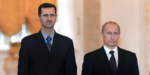 MOSCOW, RUSSIAN FEDERATION: Russian President Vladimir Putin (C-R), his wife Lyudmila (L), Syrian President Bashar al-Asad (C-L) and his wife Asma pose for a picture during their meeting in Moscow's Kremlin, 25 January 2005. Russia and Syria have reached a deal on restructuring debt owed by Syria left over from the Soviet era, the Syrian and Russian presidents announced after Kremlin talks. AFP PHOTO / POOL / SERGEI CHIRIKOV (Photo credit should read SERGEI CHIRIKOV/AFP/Getty Images)