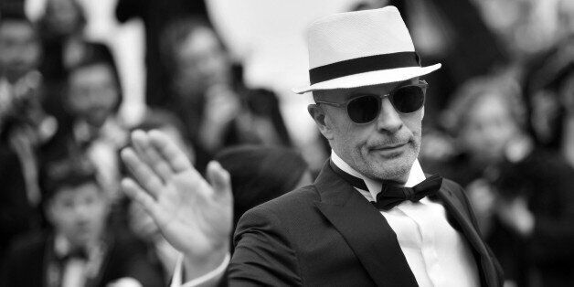 French director Jacques Audiard waves as he arrives for the closing ceremony of the 68th Cannes Film Festival in Cannes, southeastern France, on May 24, 2015. AFP PHOTO / BERTRAND LANGLOIS (Photo credit should read BERTRAND LANGLOIS/AFP/Getty Images)