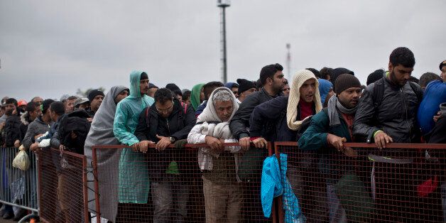 People queue in order to get inside a reception center for migrants and refugees in Opatovac, Croatia, Friday, Sept. 25, 2015. Croatian police say some 55,000 migrants have crossed into the country from Serbia since last Wednesday when the first groups started arriving. (AP Photo/Marko Drobnjakovic)
