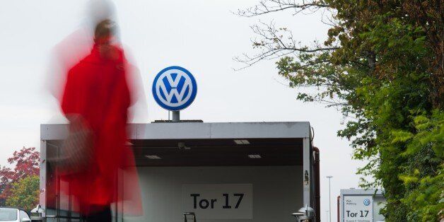 A woman arrives at gate 17 of the plant of German car maker Volkswagen (VW) in Wolfsburg, central Germany, on October 6, 2015. Several engineers at scandal-hit German automaker Volkswagen had admitted to installing the device in the company's cars aimed at cheating pollution tests. The global scam had wiped more than 40 percent off Volkswagen's market capitalisation and led chief executive Martin Winterkorn to resign. AFP PHOTO / DPA / JULIAN STRATENSCHULTE +++ GERMANY OUT +++ (Photo credit should read JULIAN STRATENSCHULTE/AFP/Getty Images)