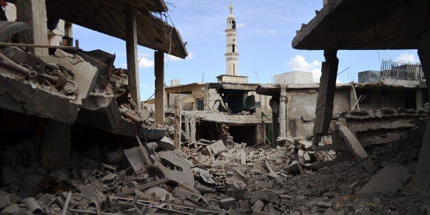 A picture taken on September 30, 2015 shows damaged buildings and a minaret in the central Syrian town of Talbisseh in the Homs province. Russian warplanes carried out air strikes in three Syrian provinces, including Homs, along with regime aircraft on September 30, according to a Syrian security source. Earlier in the day, the Syrian Observatory for Human Rights, a Britain-based monitor, reported at least 27 civilians had been killed in air strikes in the Homs province, adding that the strikes hit Rastan, Talbisseh and Zaafarani. The other Syrian security source said the Russian strikes had hit Rastan and Talbisseh in the province of Homs. AFP PHOTO / MAHMOUD TAHA (Photo credit should read MAHMOUD TAHA/AFP/Getty Images)