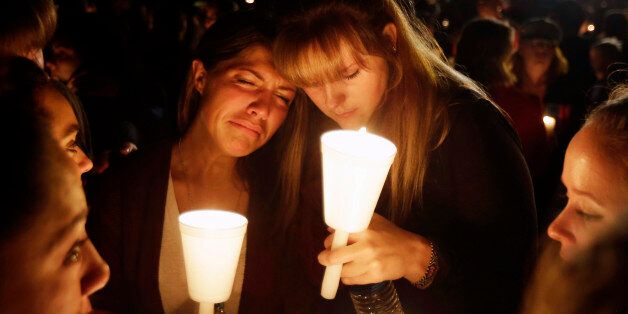Kristen Sterner, left, and Carrissa Welding, both students of Umpqua Community College, embrace each other during a candle light vigil for those killed during a fatal shooting at the college, Thursday, Oct. 1, 2015, in Roseburg, Ore. (AP Photo/Rich Pedroncelli)