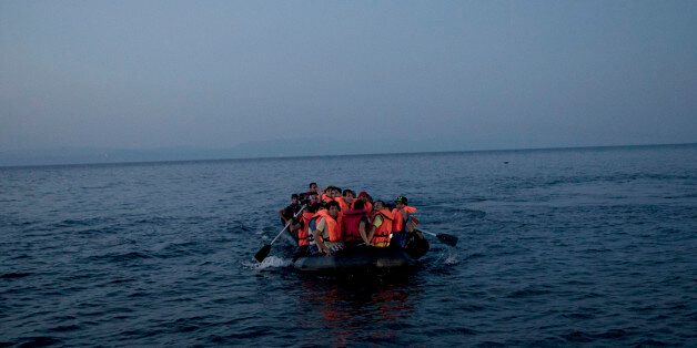 Syrian refugees arrive aboard a dinghy after crossing from Turkey, to the island of Lesbos, Greece, on Sunday, Sept. 20, 2015. Greece's coast guard was searching Sunday for 26 migrants missing off the coast of the eastern Aegean island of Lesbos after the boat they were traveling in sank.(AP Photo/Petros Giannakouris)