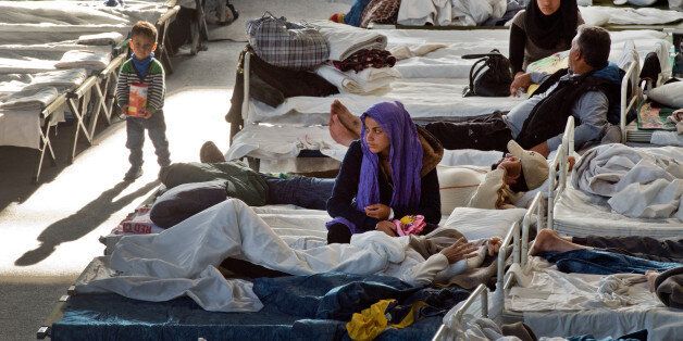 Migrants rest in a shelter in Hanau, central Germany, Thursday Sept. 24, 2015. Around 700 refugees mostly from Syria and Afghanistan live in that accommodation at the moment. (Boris Roessler/dpa via AP)