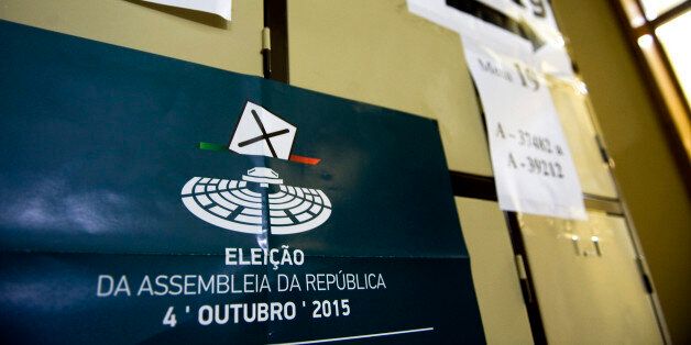 A poster for the national election sits on lockers in a public school used as a polling station during the Portuguese election, in Massama near Lisbon, Portugal, on Sunday, Oct. 4, 2015. Portuguese voters are casting their ballots Sunday in the first general election since 2011, with polls signaling the government that led the nation out of an international bailout may be re-elected. Photographer: Paulo Duarte/Bloomberg via Getty Images
