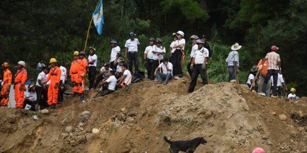 Rescuers, firemen and residents take part in the rescue operations after a landslide late Thursday, following heavy rains, covered part of the village of El Cambray II, in Santa Catarina Pinula municipality, some 15 km east of Guatemala City, on October 2, 2015. At least nine people were killed and about 600 others missing following a landslide that damaged some 125 homes on the outskirts of the Guatemalan capital, an official said Friday, noting that the death toll could rise as rescue efforts