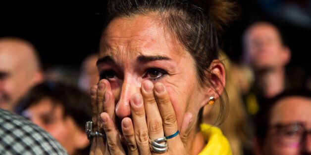 BARCELONA, SPAIN - SEPTEMBER 27: People react to results from the regional elections held in Catalonia on September 27, 2015 in Barcelona, Spain. The main Catalanist parties, Catalan Democratic Convergence 'Convergencia Democratica de Catalunya' party (CDC), Republican Leftist of Catalonia 'Esquerra Republicana de Catalunya' party (ERC) and a group of social associations have joined together to form a Catalan pro-independence coalition 'Junts pel Si' (Together for the Yes). Over 5 million Catalans are called to vote in Parliamentary elections on September 27, with opinion polls predicting that the majority of seats will be won by pro-independence parties, which could lead to a push for independence in Catalonia. (Photo by Alex Caparros/Getty Images)