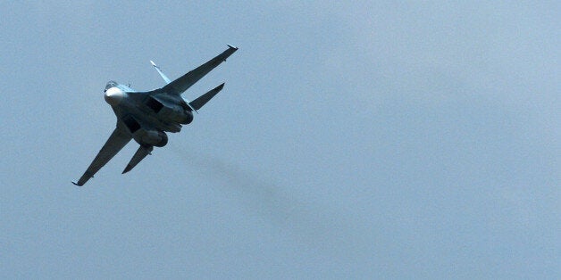 A Russian SU-30 fighter jet flies during Venezuela's independence day military parade in Fort Tiuna in Caracas, Venezuela, Wednesday, July 5, 2006. Venezuela has bought 100,000 Russian-made AK-103 assault rifles, 15 Russian military helicopters and wants to close a deal for 24 Sukhoi fighter jets, when Chavez travels to Moscow later this month. (AP Photo/Gregorio Marrero)