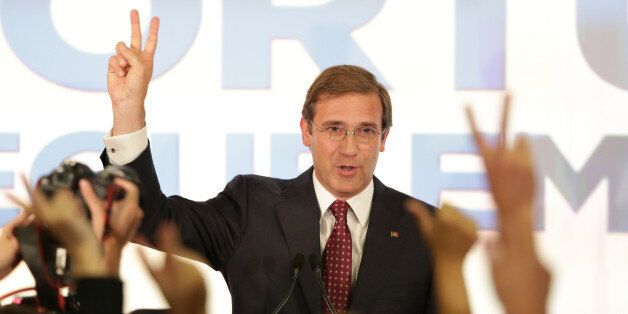 Portuguese Prime Minister Pedro Passos Coelho gestures to supporters following the announcement of the results of Portugal's general elections Sunday, Oct. 4 2015, in Lisbon. Opinion polls prior to the vote predicted a close contest. (AP Photo/Armando Franca)
