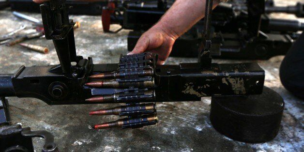 Iraqi Kurdish, Hama Sour works at his workshop where he repairs all types of weapons for Kurdish Peshmerga fighters fighting against Islamic State (IS) group jihadiststs, on September 12, 2015 in the town of Kure, 40 kilometers north of Arbil, the capital of the autonomous Kurdish region of northern Iraq. AFP PHOTO / SAFIN HAMED (Photo credit should read SAFIN HAMED/AFP/Getty Images)