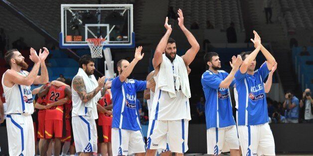 (From L) Greece's power forward Kostas Kaimakoglou, Greece's power forward Georgios Printezis, Greece's shooting guard Vassilis Spanoulis and Greece's center Yannis Bourousis react after Greece defeated Belgium in their round of 16 basketball match at the EuroBasket 2015 in Lille, northern France, on September 12, 2015. AFP PHOTO / PHILIPPE HUGUEN (Photo credit should read PHILIPPE HUGUEN/AFP/Getty Images)