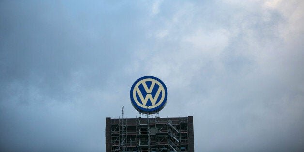 A VW logo sits above a building under construction at the Volkswagen AG headquarters in Wolfsburg, Germany, on Wednesday, Sept. 23, 2015. Volkswagen's escalating scandal over emissions-test cheating is beginning to ripple across the $10 trillion global corporate bond market. Photographer: Krisztian Bocsi/Bloomberg via Getty Images