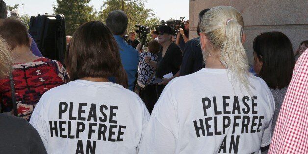 Ericka Glossip-Hodge, left, daughter of Richard Glossip, and Billie Jo Ogden Boyiddle, right, Richard Glossip's sister, listen during a rally to stop the execution of Richard Glossip, in Oklahoma City, Tuesday, Sept. 15, 2015. Glossip is scheduled to be executed Wednesday, Sept. 16. (AP Photo/Sue Ogrocki)