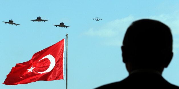 ANKARA, TURKEY - AUGUST 30: President of Turkey Recep Tayyip Erdogan watches the performance of the aerobatic demonstration team of the Turkish Air Force 'Turkish Stars' in Ankara, Turkey on 30 August, 2014. (Photo by Kayhan Ozer/Anadolu Agency/Getty Images)