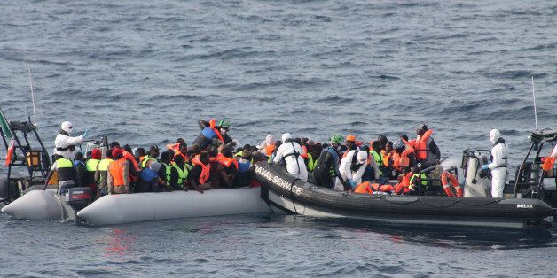 In this picture taken on June 6, 2015 and made available on Monday, June 8, 2015, provided by Irish Defence Forces, officers of the Irish Navy ship Le Eithne rescue migrants in the Mediterranean Sea. Heartened by recent election successes by an anti-immigrant party, Italian politicians based in the north vowed Sunday not to shelter any more migrants saved at sea, even as thousands more were being rescued in the Mediterranean from smugglers' boats in distress. (Irish Defence Forces via AP)
