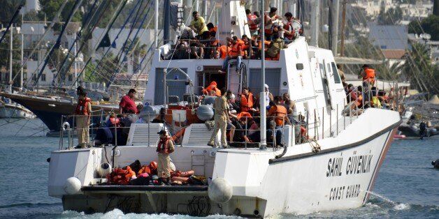 MUGLA, TURKEY - SEPTEMBER 15: Turkish Coast Guard rescue refugees after a vessel with refugees on board sailing from the Bodrum coast to the nearby Greek island of Kos, sank off Turkey's Aegean coast Bodrum, Turkey on September 15, 2015. Over 200 people rescued by Turkish Coast Guard from sunken Kos-bound vessel. 22 people have died after a boat carrying refugees sank early Tuesday in the Aegean Sea off Turkey's southwestern Mugla coast. (Photo by Ali Balli/Anadolu Agency/Getty Images)