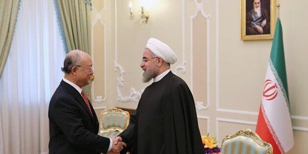 TEHRAN, IRAN - SEPTEMBER 20: International Atomic Energy Agency (IAEA) Director General Yukiya Amano (L) is welcomed by Iranian President Hassan Rouhani (R) prior to their meeting at the presidential palace in Tehran, Iran on September 20, 2015. (Photo by Pool/Iranian Presidency Press Office /Anadolu Agency/Getty Images)