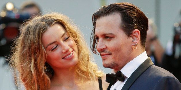 Amber Heard, left, and Johnny Depp pose for photographers upon arrival at the premiere of the film Black Mass during the 72nd edition of the Venice Film Festival in Venice, Italy, Friday, Sept. 4, 2015. The 72nd edition of the festival runs until Sept. 12. (AP Photo/Andrew Medichini)