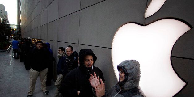 A line of people waiting to purchase the new Apple iPad mini snake around the side of the Apple store on Michigan Ave. Friday, Nov. 2, 2012 in Chicago. Apple's new 7.9 inch tablet went on sale at 8:00 A.M. CDT at the store. (AP Photo/M. Spencer Green)