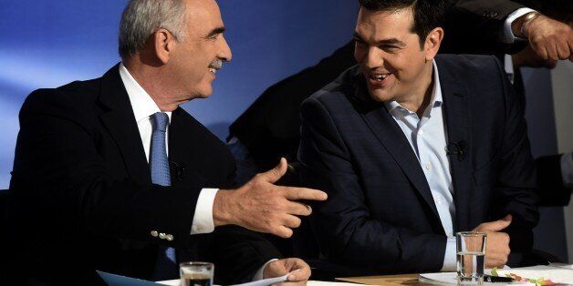 Former Prime Minister and leader of SYRIZA party Alexis Tsipras (R) and leader of the conservative New Democracy party Vangelis Meimarakis (L) schat before a pre-election televised debate between the main party leaders in Athens on September 9, 2015. With just 11 days until the country heads to the polls, seven leaders including former leftist prime minister Alexis Tsipras and conservative challenger Vangelis Meimarakis will cross swords in a debate which will be shown at 1800 GMT on state broad