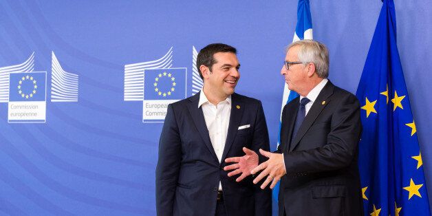 European Commission President Jean-Claude Juncker, right, welcomes Greece's Prime Minister Alexis Tsipras upon his arrival at the EU Commission headquarters in Brussels on Wednesday, Sept. 23, 2015. The European Union hopes to provide more funds for refugees and agree short and long term measures to confront the migration crisis. (AP Photo/Geert Vanden Wijngaert)