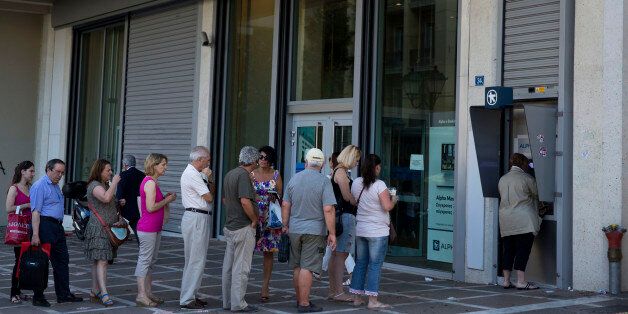 People line up to use an ATM machine outside a bank in Athens, on Monday, July 6, 2015. Greeceâs Finance Minister Yanis Varoufakis has resigned following Sundayâs referendum in which the majority of voters said ânoâ to more austerity measures in exchange for another financial bailout. (AP Photo/Petros Giannakouris)