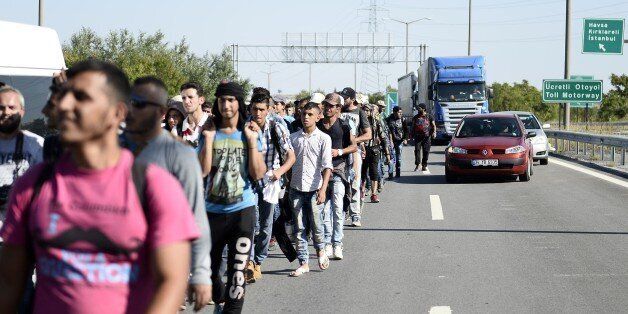 EDIRNE, TURKEY - SEPTEMBER 18 : Refugees who want to go to Europe walk towards the Edirne city center in Edirne, Turkey on September 18, 2015. Hundreds of refugees hoping to cross the Turkish border into Greece or Bulgaria will be removed by the weekend, the governor of Erdine province said Thursday. (Photo by Berk Ozkan/Anadolu Agency/Getty Images)