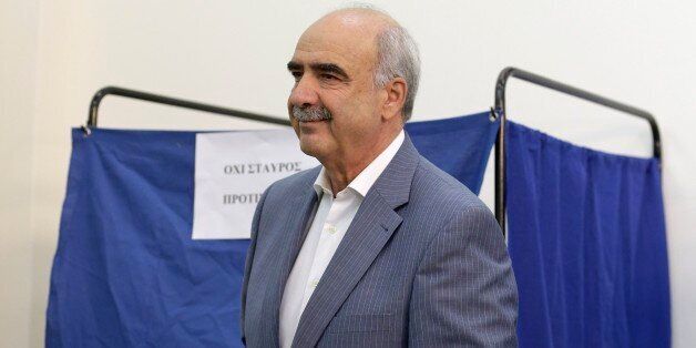 Leader of New Democracy main opposition party Vangelis Meimarakis casts his vote at a polling station in Athens, Sunday, Sept. 20, 2015. Greeks were voting Sunday in their third national polls this year, called on to choose who they trust to steer the country into its new international bailout. (AP Photo/Thanassis Stavrakis)