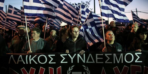 Supporters of the Greek far-right Golden Dawn party take part in a rally in Athens, on Saturday, March 21, 2015. The party organised a rally to protest policies over illegal immigration during the U.N.'s International Day for the Elimination of Racial Discrimination. (AP Photo/Panayiotis Tzamaros)