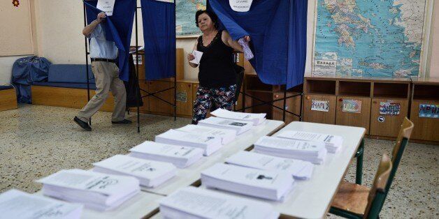 A woman exits a polling booth prior to cast her ballot in central Athens on September 20, 2015. Over 9.8 million Greeks were registered to vote in an election that will select a new government to implement a three-year bailout adopted by the country's parliament last month. AFP PHOTO/ LOUISA GOULIAMAKI (Photo credit should read LOUISA GOULIAMAKI/AFP/Getty Images)